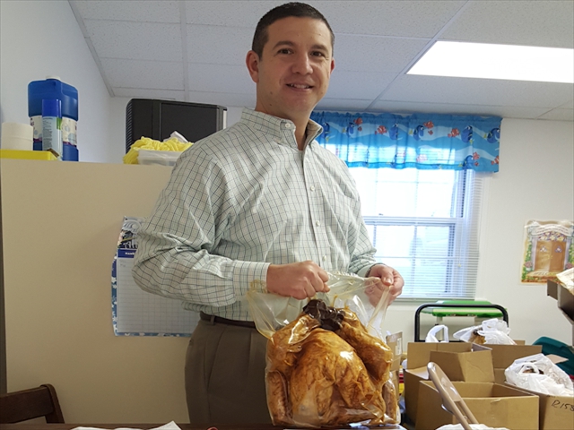 Jerry Biller readying a turkey for give-away on November 19.  The Rotary Club, in cooperation with the New Market Food Pantry, gave away vouchers for food and 70 turkeys. 